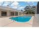 Beautiful backyard pool with screened-in lanai, offering a private oasis at 11411 Terrell, Spring Hill, FL 34606