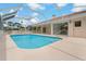 Sparkling swimming pool with a screened enclosure and covered patio at 11411 Terrell, Spring Hill, FL 34606