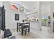 Inviting dining area with a modern light fixture, a table with stools, and a view into the kitchen at 11613 Sunshine Pond Rd, Tampa, FL 33635