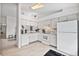 Bright, open-concept kitchen with white cabinets and modern appliances, seamlessly flowing into other areas at 11613 Sunshine Pond Rd, Tampa, FL 33635