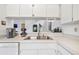 Bright kitchen area featuring a stainless steel sink, white cabinets and white countertops at 11613 Sunshine Pond Rd, Tampa, FL 33635