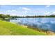 Scenic lake view with lush green shoreline and blue sky reflected in the calm water at 11613 Sunshine Pond Rd, Tampa, FL 33635