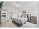 Calming main bedroom with carpeted floors, gray bedding, ensuite bathroom and modern decor at 11613 Sunshine Pond Rd, Tampa, FL 33635