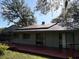 A spacious backyard features a wooden deck and a home with solar panels at 12206 N 53Rd St, Temple Terrace, FL 33617