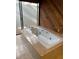 Bathroom features a tiled jetted tub with a tile surround and a large window at 12206 N 53Rd St, Temple Terrace, FL 33617