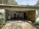 A large garage with concrete flooring contains a yellow shelf and wash sink at 12206 N 53Rd St, Temple Terrace, FL 33617