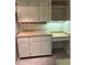 White cabinets, tile floors and dedicated desk space in this well lit kitchen at 12206 N 53Rd St, Temple Terrace, FL 33617