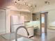 Bright kitchen featuring a double basin sink and white appliances and cabinetry at 12206 N 53Rd St, Temple Terrace, FL 33617