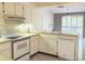 Bright kitchen featuring stainless steel appliances and white cabinetry at 12206 N 53Rd St, Temple Terrace, FL 33617