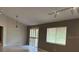 Open-concept living room featuring a vaulted ceiling, track lighting and tile flooring at 12206 N 53Rd St, Temple Terrace, FL 33617