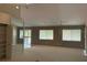 Spacious living room with three large windows and track lighting at 12206 N 53Rd St, Temple Terrace, FL 33617