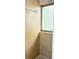 This tiled shower features a window and a chrome showerhead at 12206 N 53Rd St, Temple Terrace, FL 33617