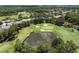 Aerial view of golf course featuring a pond and sand traps at 12209 Glencliff Cir, Tampa, FL 33626