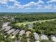 Aerial view of a residential area with beautiful landscaping, trees, and a golf course in the background at 12209 Glencliff Cir, Tampa, FL 33626