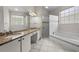 Bathroom featuring double sinks, granite counters, a soaking tub, and a glass-enclosed shower at 12209 Glencliff Cir, Tampa, FL 33626