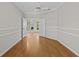 Spacious bedroom with hardwood floors, crown molding, and doors opening to a living area at 12209 Glencliff Cir, Tampa, FL 33626