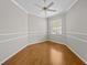 Bright bedroom featuring wood floors, a ceiling fan, neutral paint, and a large window at 12209 Glencliff Cir, Tampa, FL 33626