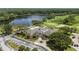 Aerial view of the clubhouse overlooking a lake and a golf course at 12209 Glencliff Cir, Tampa, FL 33626