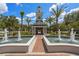 Inviting community entrance with water fountains, clock tower and landscaped surroundings at 12209 Glencliff Cir, Tampa, FL 33626