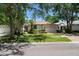 Beautiful home featuring a manicured lawn, charming landscaping, and a brick driveway at 12209 Glencliff Cir, Tampa, FL 33626