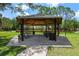 Gazebo with picnic table and trash cans surrounded by a park and trees at 12209 Glencliff Cir, Tampa, FL 33626