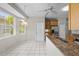 Bright kitchen area with large windows, tile flooring, granite countertops and stainless steel appliances at 12209 Glencliff Cir, Tampa, FL 33626