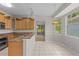 Well-appointed kitchen with wooden cabinetry, granite countertops, and ample natural light at 12209 Glencliff Cir, Tampa, FL 33626