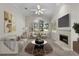 Bright living room featuring neutral decor, a fireplace, a large window and vaulted ceilings at 12209 Glencliff Cir, Tampa, FL 33626