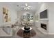 Bright living room featuring neutral decor, a fireplace, a large window and vaulted ceilings at 12209 Glencliff Cir, Tampa, FL 33626