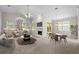 Open-concept living room with fireplace, views to the outside, and connected dining area at 12209 Glencliff Cir, Tampa, FL 33626