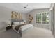 Serene main bedroom with golf view, large windows, plush carpeting, and modern decor at 12209 Glencliff Cir, Tampa, FL 33626