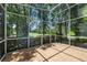 Enclosed patio with view of the golf course through trees at 12209 Glencliff Cir, Tampa, FL 33626
