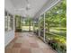 Covered and screened outdoor patio space overlooking lush landscape and a golf course at 12209 Glencliff Cir, Tampa, FL 33626