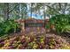 Community entrance sign in front of colorful flowering shrubs at 12209 Glencliff Cir, Tampa, FL 33626