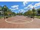 Picturesque town square with brick pavement, clock tower, benches, and lush landscaping, inviting for relaxation at 12209 Glencliff Cir, Tampa, FL 33626