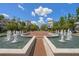 Beautiful water fountain in a brick-paved plaza, flanked by elegant buildings and lush greenery for a scenic view at 12209 Glencliff Cir, Tampa, FL 33626