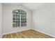 Bedroom featuring hardwood floors, vaulted ceiling and a beautiful window with a view to the front yard at 12335 Glenfield Ave, Tampa, FL 33626