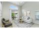 Bright living room with stylish decor, large windows, and access to the outdoor patio at 12335 Glenfield Ave, Tampa, FL 33626