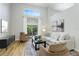 Cozy living room with plush seating, a modern entertainment center, and sliding doors to the outdoor patio at 12335 Glenfield Ave, Tampa, FL 33626