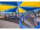 Community playground with bright yellow and blue shade structure and fun climbing web at 12335 Glenfield Ave, Tampa, FL 33626