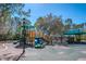 Community playground with multiple slides, play structures, and covered seating areas at 12335 Glenfield Ave, Tampa, FL 33626