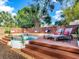 Inviting backyard deck with a stock tank pool, comfortable lounge chairs, and built-in bench seating at 1243 55Th N Ave, St Petersburg, FL 33703