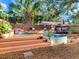 Backyard deck with stock tank pool, seating area, and stylish gravel landscaping for a serene retreat at 1243 55Th N Ave, St Petersburg, FL 33703