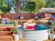 This backyard retreat features a stylish stock tank pool and a cozy seating area on a wooden deck at 1243 55Th N Ave, St Petersburg, FL 33703
