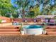 Backyard deck with stock tank pool, seating area, and lush landscaping for a relaxing outdoor experience at 1243 55Th N Ave, St Petersburg, FL 33703
