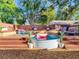 Entertainer's backyard featuring a stock tank pool, a wooden deck, and lush landscaping at 1243 55Th N Ave, St Petersburg, FL 33703