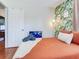 Relaxing bedroom with colorful bedding, leafy accent wall, and convenient access to the door at 1243 55Th N Ave, St Petersburg, FL 33703