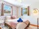 Airy bedroom with crane wallpaper, two windows, and neutral tones for a tranquil space at 1243 55Th N Ave, St Petersburg, FL 33703