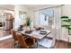 Dining room featuring a wood table, modern chairs, and natural light from a large window at 1243 55Th N Ave, St Petersburg, FL 33703