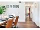 This dining area showcases wood floors, minimalist wall art, and an inviting view into an adjacent room at 1243 55Th N Ave, St Petersburg, FL 33703